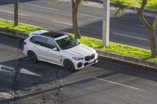 White bmw x5 suv parking on urban street