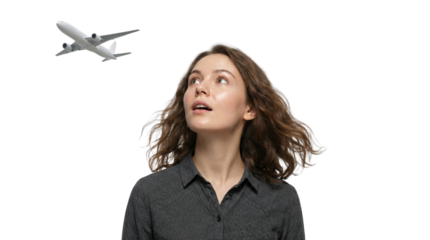 Young Woman Looking Up at White Passenger Airplane Flying Overhead