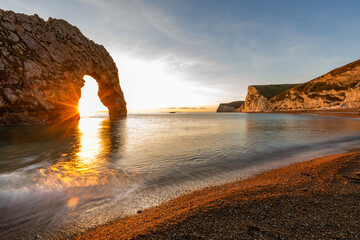Durdle Door sea arch at sunset Dorset England