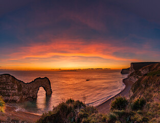 Durdle Door sea arch at sunset Dorset England