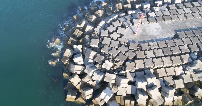 Aerial view of harbor breakwater with lighthouse The concept of safety