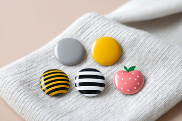 Cute pins and badges arranged on fabric look so adorable