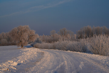 Obraz premium A cleared country road at a winter sunrise