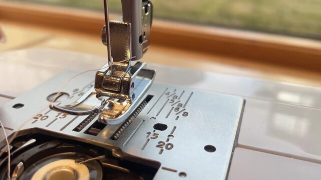Threading a needle on a sewing machine with white thread