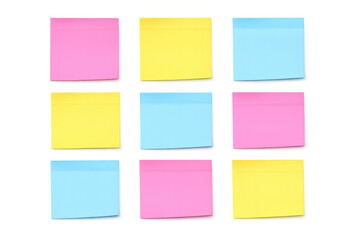 Group of nine bright pink, yellow, and blue blank adhesive paper notes, presenting clean space for text and ideas
