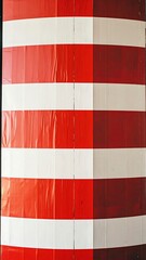 A striped column featuring alternating bands of red and white, vertically aligned with varying light exposure