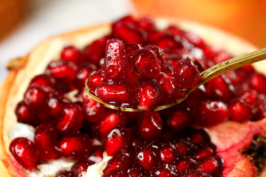 Fresh Pomegranate Seeds on Spoon - Healthy Red Fruit