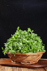 Naklejka premium Fresh Wild Vegetables in Basket - Traditional Qingming Festival Food