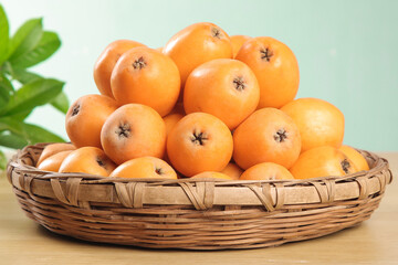 Fresh Oranges in Woven Basket with Green Leaves