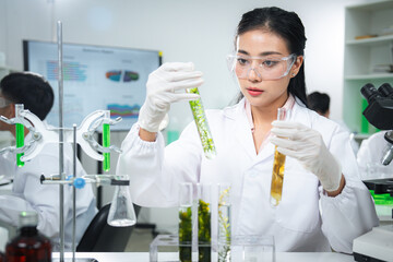 Scientist examining plant-based samples in a modern laboratory, representing sustainability,...