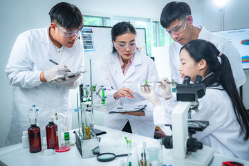 Fototapeta premium Team of scientists collaborating on algae and plant-based bioenergy research in laboratory, representing renewable energy testing clean technology innovation, sustainability, and ESG-focused corporate