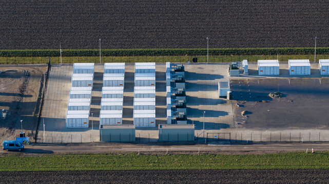 Dronter, Netherlands - 14 January 2026: Aerial view of rows of gleaming white storage containers contrasting against the dark, tilled earth, bathed in the cool light of a winter's day.