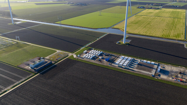 Dronter, Netherlands - 14 January 2026: Aerial view of the Dronter Energy Storage facility, where geometric fields meet industrial infrastructure under a clear winter sky.
