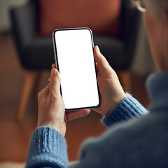 Elderly hands holding smartphone with empty screen while relaxing at home