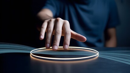 Obraz premium A human hand reaches to touch a bright glowing orange light circle with blue digital streams on a dark futuristic surface
