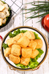 Golden Fried Tofu Cubes on Lettuce Leaves - Delicious Asian Vegetarian Dish