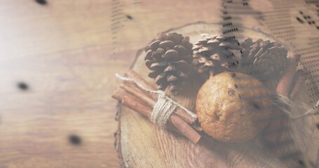 Obraz premium Showing arrangement on wooden table with slice, three cones, tied cinnamon, muffin, printed overlay