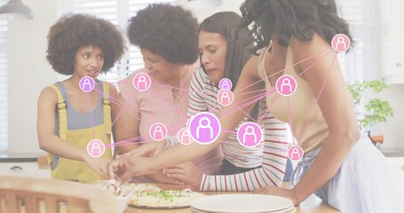 Preparing four women in overalls, apron arranging pizza toppings at home, with pink network overlay