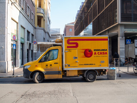 Esselunga A Casa delivery truck on a Milan street, showcasing grocery retail and essential commerce services