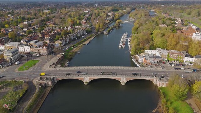 The drone aerial footage of Hampton court bridge. The Bridge crosses the River Thames in England between Hampton, London and East Molesey, Surrey.