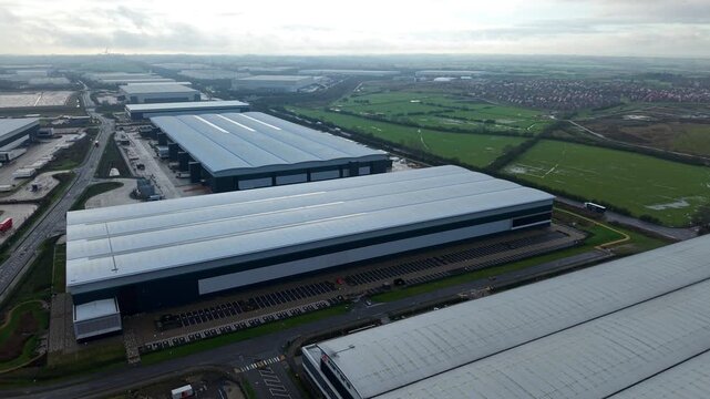 Northampton, United Kingdom - 17 January 2026: Aerial view of Royal Mail Midlands Super Hub, a sprawling complex of warehouses under a muted, overcast sky.