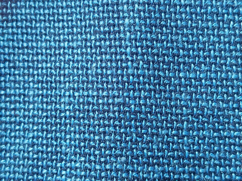 Fondo de textura de tela tejida con hilos de color azul turquesa