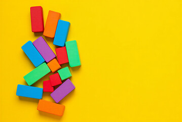 Colorful rectangular blocks arranged on bright yellow background for creative play or educational purposes at home or school  learning through play