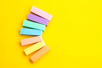 Colorful sticky notes on yellow background for office or school use  various pastel colors arranged neatly  educational supplies