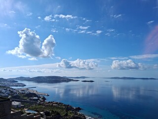 Panoramic view of Mykonos harbor from hilltop overlooking calm sea
