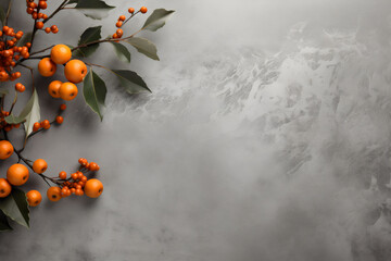 Orange berries on branch with green leaves on textured grey background. Autumn nature flat lay with copy space for text. Minimalist seasonal decoration