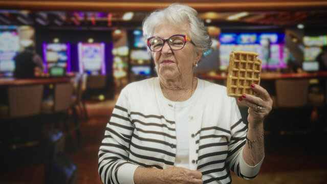Woman holds waffle in right hand, left hand resting on lap inside casino building with slot machines visible; skepticism humor.