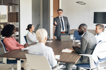 Business leader speaking at diverse corporate meeting