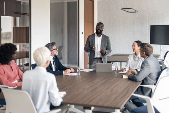 Diverse business professionals having corporate meeting in boardroom