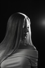 Obraz premium Black and white photos of a girl on a black background. Beautiful young model