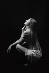Black and white photos of a girl on a black background. Beautiful young model