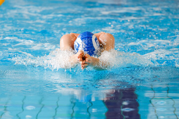 Swimmer Performing Breaststroke in a Swimming Pool