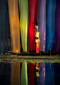 A three generational family involved in the traditional trade of hand-made dyed cloth, Inle lake, Myanmar.