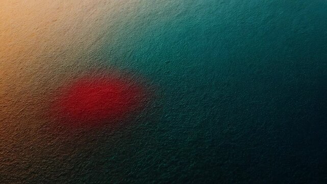 Abstract gradient of warm orange to deep teal with a blurred red oval