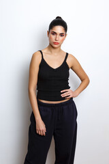 Simple portrait of a woman in casual clothing against a plain background