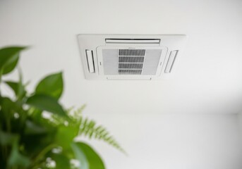Modern Ceiling Mounted Air Conditioner Unit in a Bright Room with Green Plants.