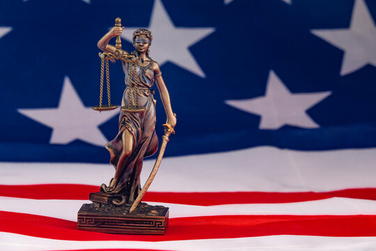 Statue of Justice with American Flag, Symbol of Law and Freedom