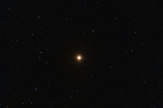 Red supergiant Betelgeuse in the Orion constellatoim among stars on dark night sky