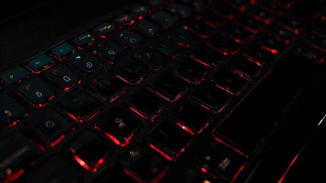Close-up of a dark keyboard with glowing red backlit keys