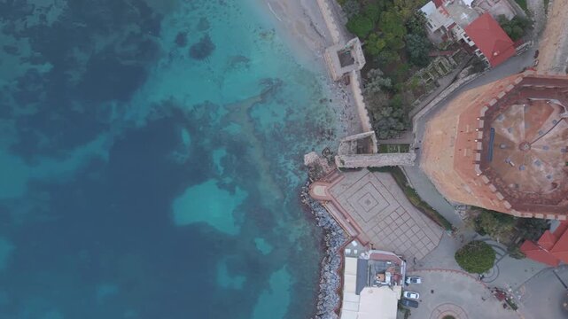 From Alanya&rsquo;s Red Tower (Kizil Kule) towards sea, top down view, left movement, aerial