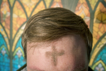 Person observing ash wednesday with ash cross