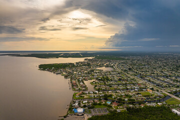 Obraz premium Hurricane season in Florida. Rainstorm sweeping across Charlotte Harbor. Heavy precipitation and moving storm clouds in humid subtropical climate.