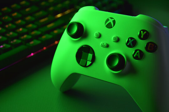 The white Xbox controller with green light.