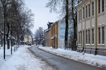 old town street with small houses in winter. Jaunjelgava town, Latvia. Snow on street