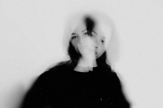 Woman's abstract portrait exploring themes of identity, struggle, and double exposure