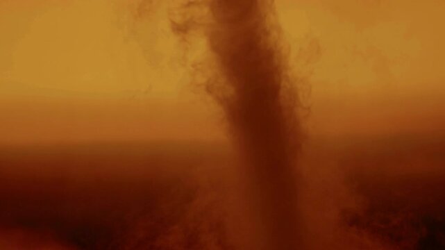 Desert Dust Devil at Sunset: A majestic dust devil swirls across a desert landscape at sunset, creating a dramatic and awe-inspiring spectacle of nature's raw power.